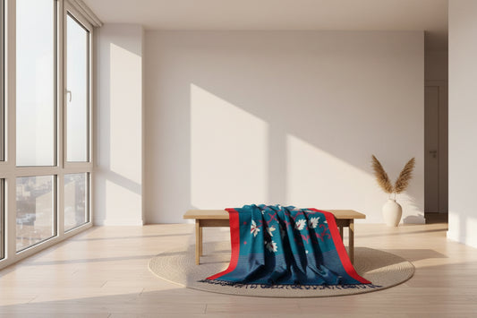 Blue saree with red border and white patterns on a white background