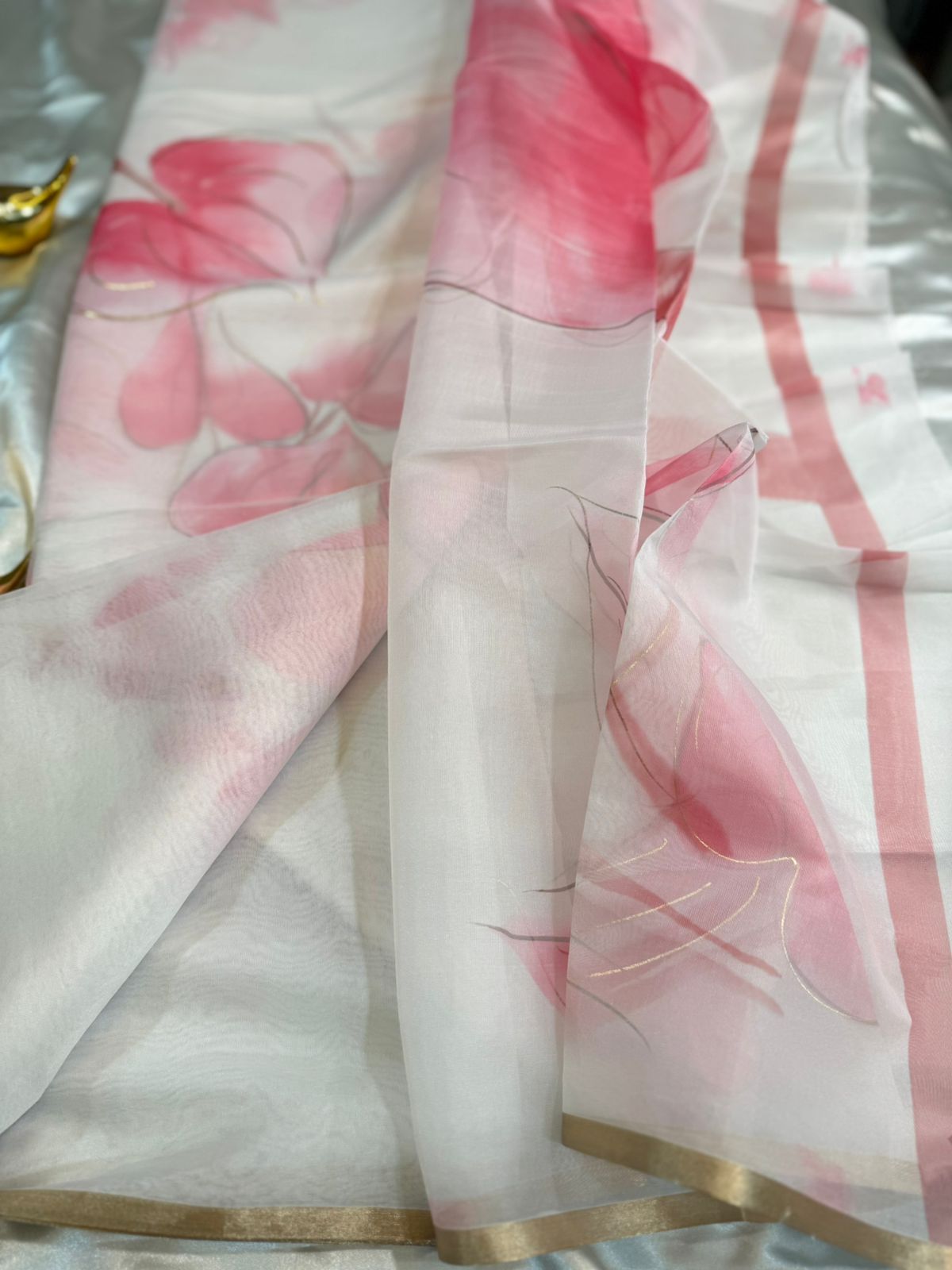 White Organza Saree with Pink Floral Motifs and Gold Border